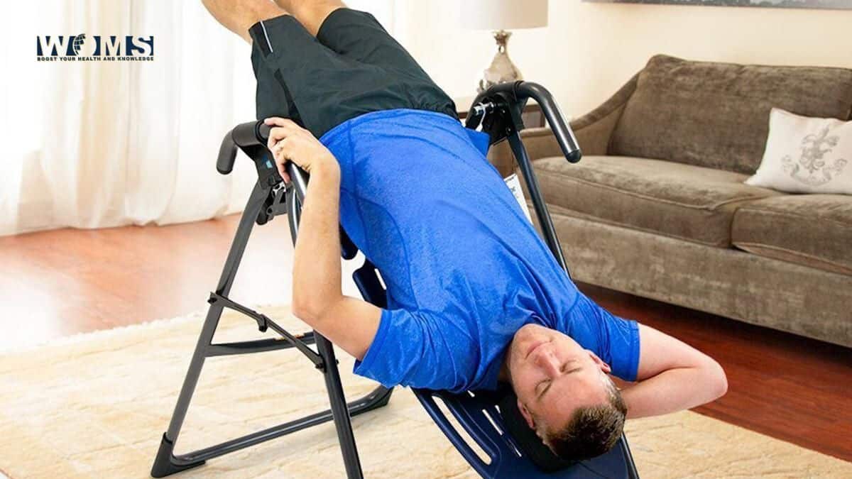 a man takeing Inversion Therapy