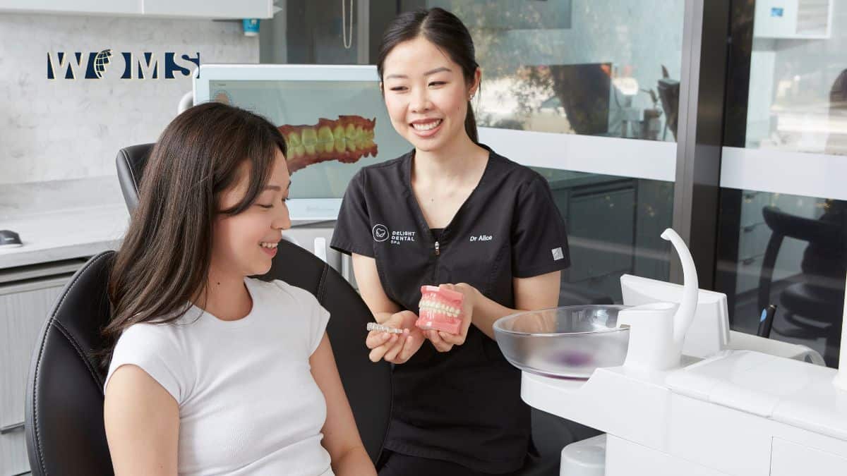 A dentist discusses Invisalign treatment with patient at Delight Dental Spa.
